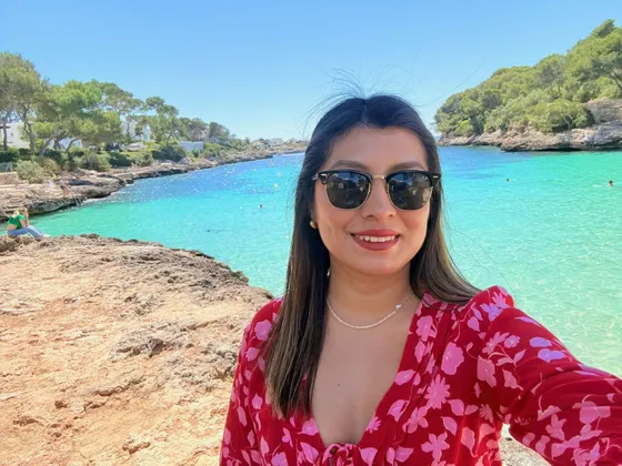 A woman in a red dress enjoying a sunny day by the sea