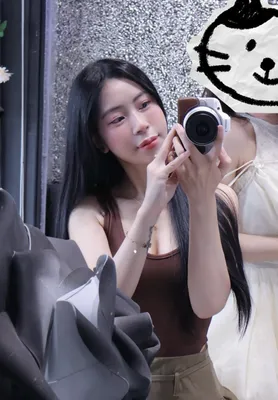 A woman taking a mirror selfie with her camera